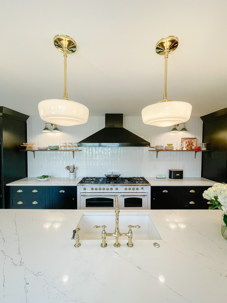 Kitchen remodel with black cabinetry and white range